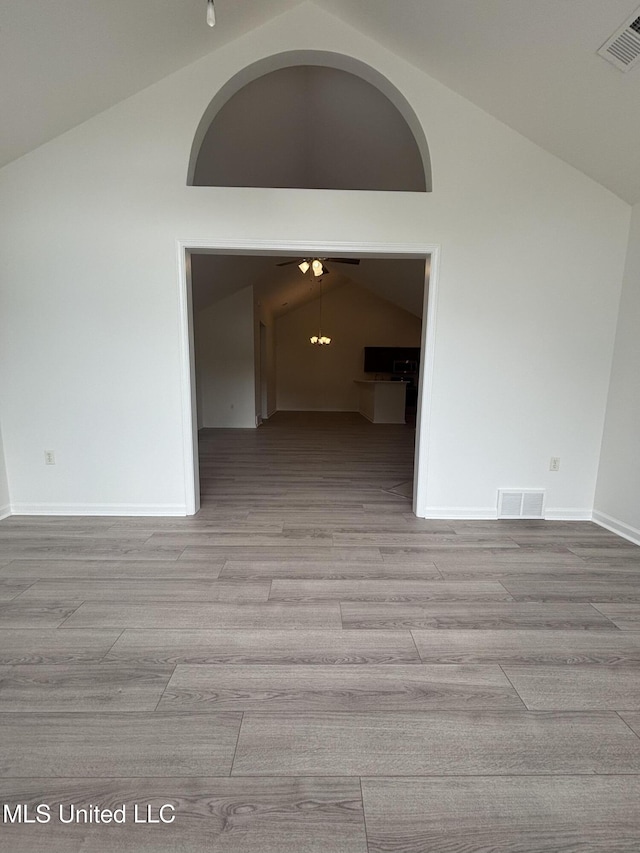 8911 Oak Branch Ln, Olive Branch, MS 38654 - unfurnished room featuring lofted ceiling, wood finished floors, and baseboards