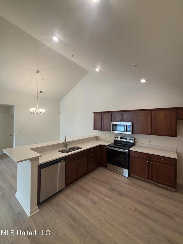 8911 Oak Branch Ln, Olive Branch, MS 38654 - kitchen with appliances with stainless steel finishes, a sink, light wood-type flooring, light countertops, and lofted ceiling