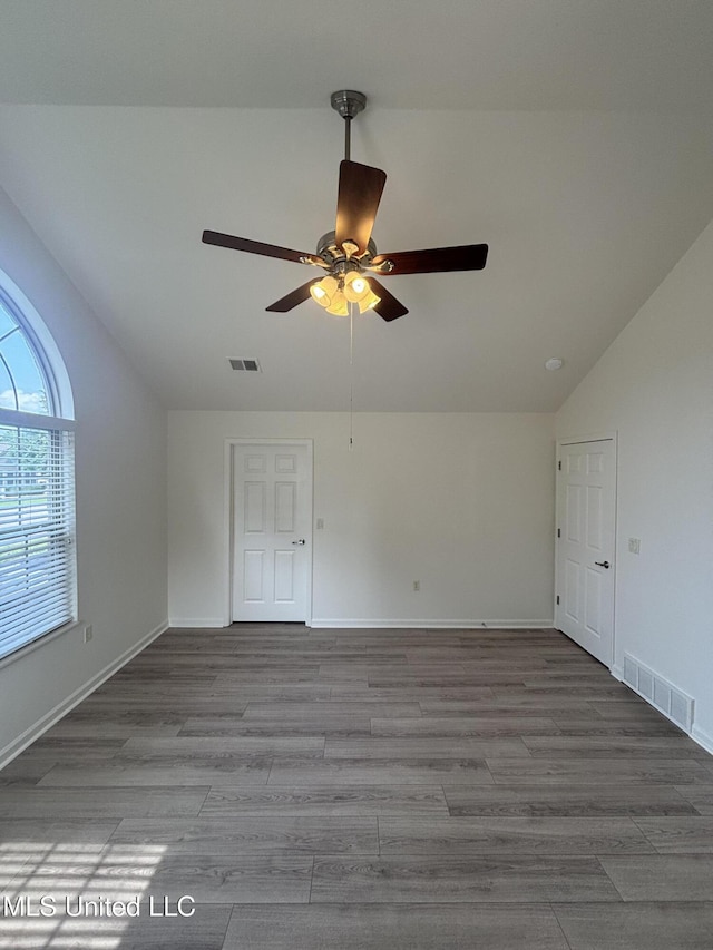 8911 Oak Branch Ln, Olive Branch, MS 38654 - spare room with vaulted ceiling, ceiling fan, wood finished floors, and baseboards