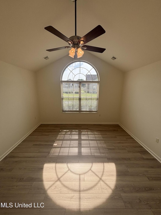 8911 Oak Branch Ln, Olive Branch, MS 38654 - unfurnished room with vaulted ceiling, a ceiling fan, wood finished floors, and baseboards