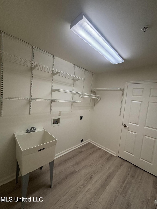 8911 Oak Branch Ln, Olive Branch, MS 38654 - washroom featuring washer hookup, wood finished floors, baseboards, and electric dryer hookup