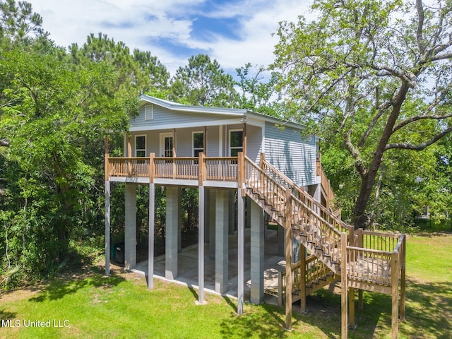 11014 Gannet St, Bay Saint Louis, MS 39520 - back of property featuring stairway, a lawn, and a patio