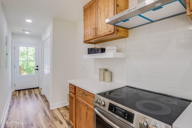 11014 Gannet St, Bay Saint Louis, MS 39520 - kitchen with electric stove, under cabinet range hood, light wood-style floors, open shelves, and baseboards