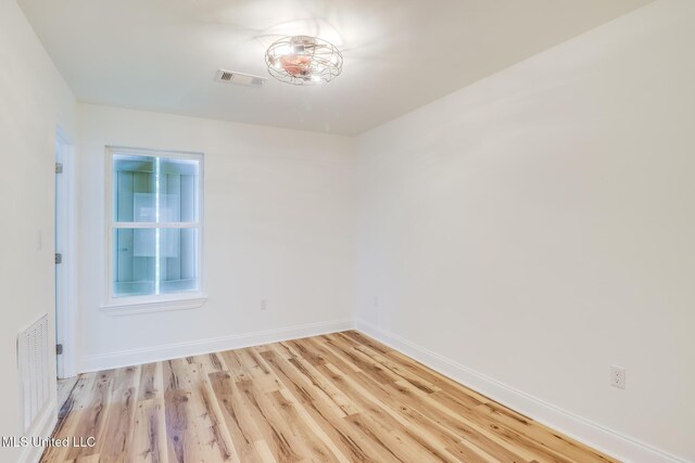 11014 Gannet St, Bay Saint Louis, MS 39520 - empty room featuring light wood-style floors and baseboards