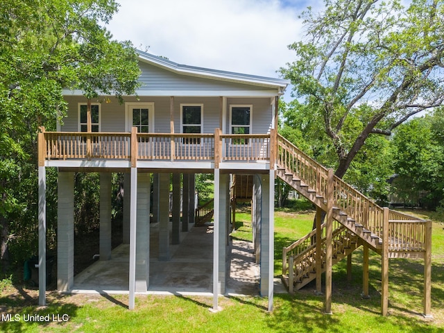 11014 Gannet St, Bay Saint Louis, MS 39520 - rear view of house featuring stairway, a yard, a carport, and a porch