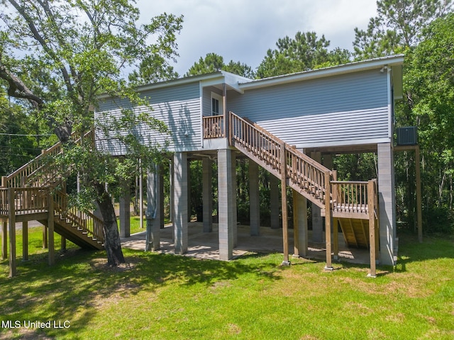11014 Gannet St, Bay Saint Louis, MS 39520 - rear view of house featuring stairway, a yard, a deck, and a patio area