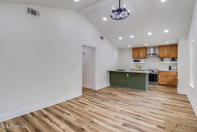 11014 Gannet St, Bay Saint Louis, MS 39520 - kitchen with wall chimney range hood, stainless steel range with electric cooktop, brown cabinets, light wood-style floors, and recessed lighting