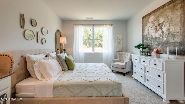 bedroom featuring light colored carpet