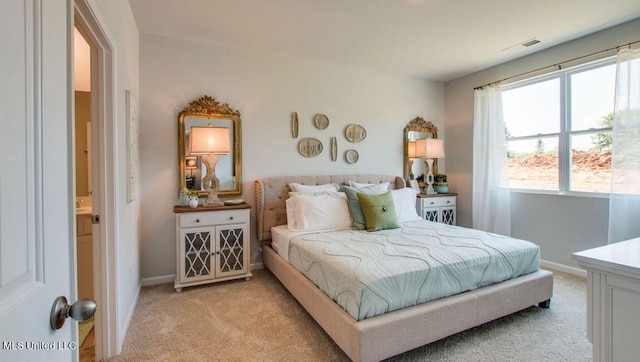 bedroom featuring light colored carpet and baseboards