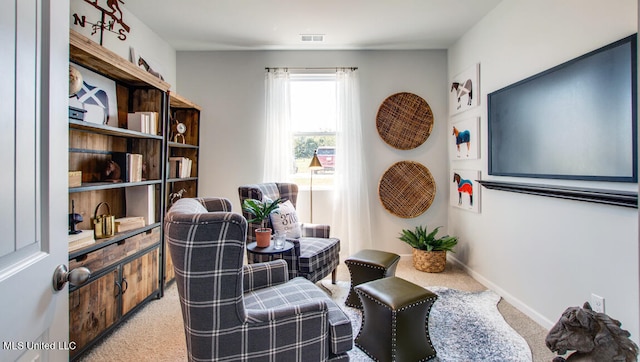 living area with light colored carpet