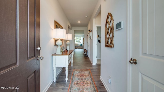 hallway with baseboards, dark wood-style flooring, and recessed lighting