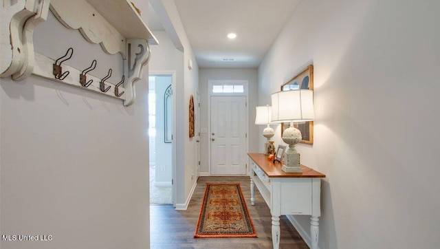 doorway featuring wood finished floors, baseboards, and recessed lighting