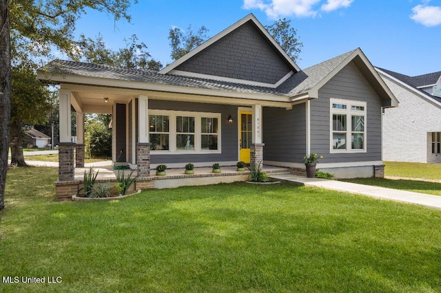 craftsman-style house featuring a porch and a front yard