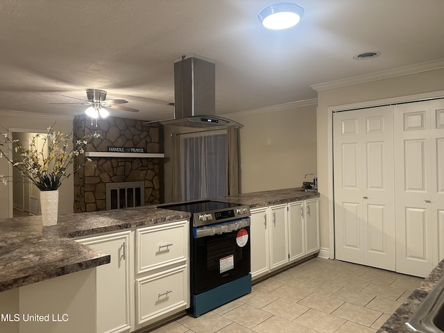 kitchen featuring kitchen peninsula, island range hood, white cabinets, and electric stove