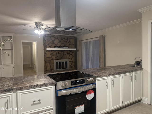 kitchen with crown molding, ceiling fan, white cabinetry, island exhaust hood, and stainless steel range with electric cooktop