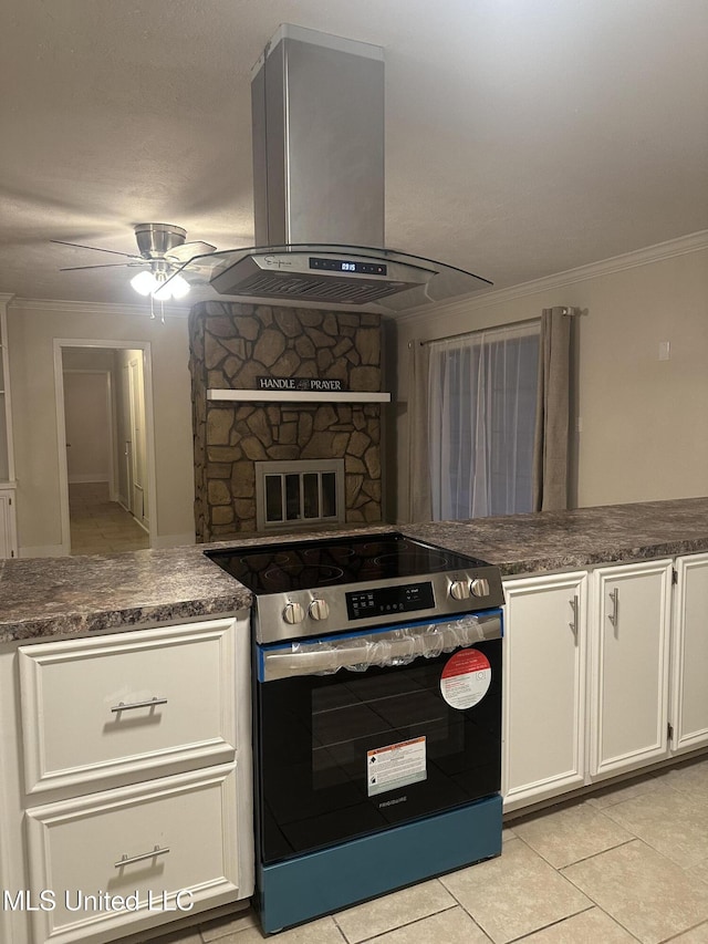 kitchen featuring white cabinetry, island exhaust hood, ornamental molding, and electric stove