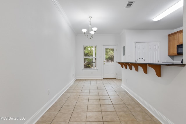 doorway featuring crown molding, light tile patterned floors, electric panel, and a chandelier