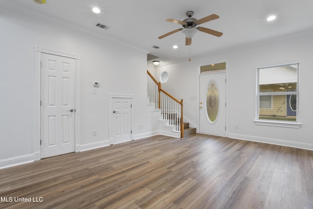 foyer featuring hardwood / wood-style flooring, crown molding, and ceiling fan