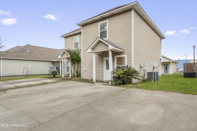 view of front property with a front yard and central air condition unit