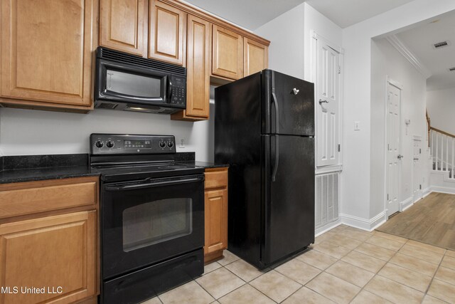 kitchen featuring ornamental molding, black appliances, and light tile patterned flooring