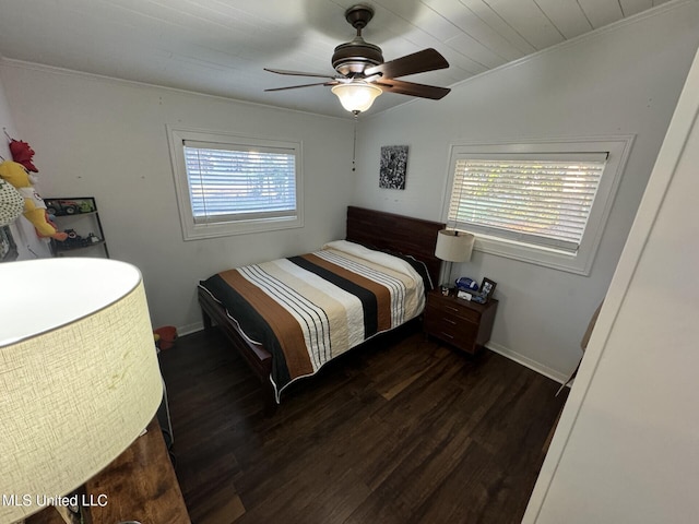 bedroom featuring wood finished floors, baseboards, and ornamental molding