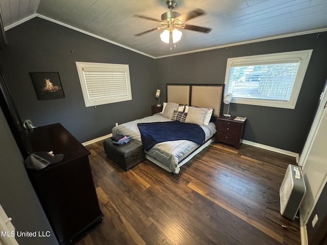 bedroom with wood finished floors, crown molding, baseboards, and vaulted ceiling