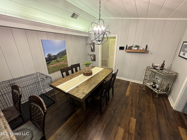 dining space featuring visible vents, ornamental molding, wood finished floors, an inviting chandelier, and baseboards