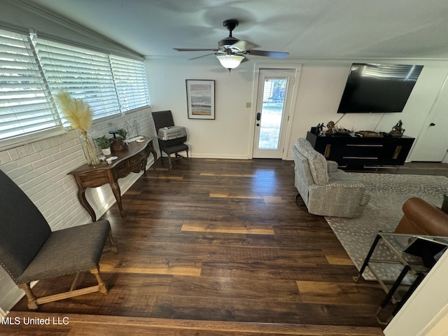 living room with baseboards, a ceiling fan, and wood finished floors