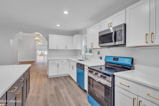 kitchen featuring a wealth of natural light, white cabinetry, sink, and appliances with stainless steel finishes