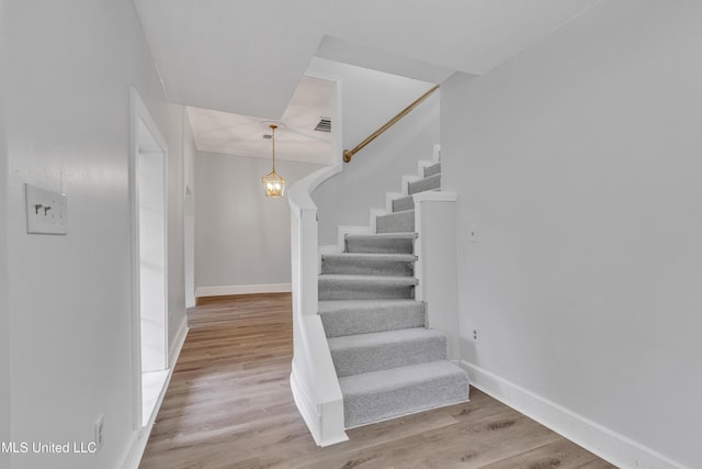 stairway with hardwood / wood-style flooring