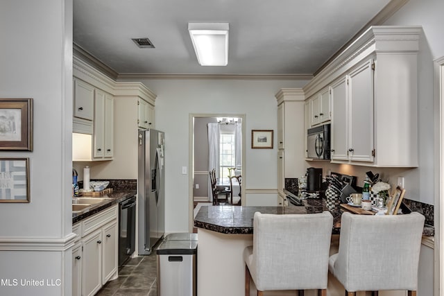 221 Boxwood Cir, Brandon, MS 39047 - kitchen featuring black appliances, dark countertops, a peninsula, crown molding, and a sink