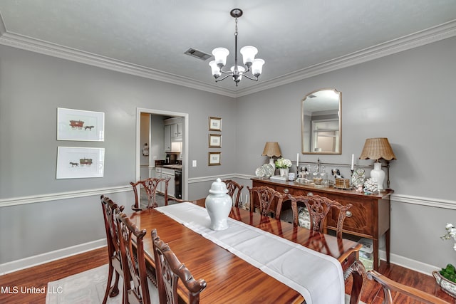221 Boxwood Cir, Brandon, MS 39047 - dining room with a chandelier, wood finished floors, ornamental molding, and baseboards