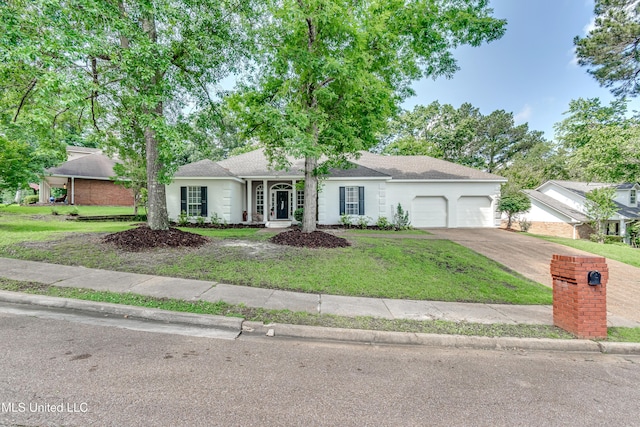 221 Boxwood Cir, Brandon, MS 39047 - ranch-style home featuring a garage, a front yard, stucco siding, and concrete driveway