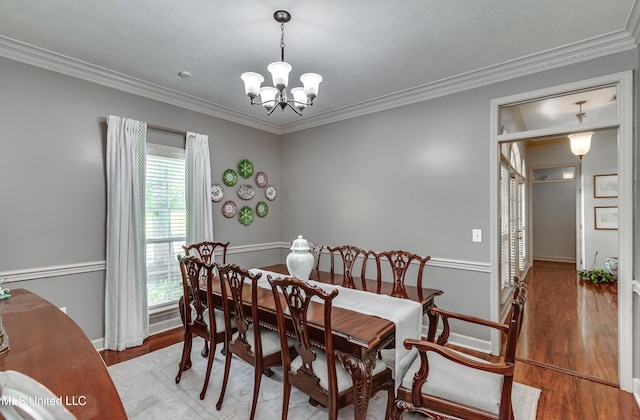 221 Boxwood Cir, Brandon, MS 39047 - dining area with a chandelier, crown molding, wood finished floors, and baseboards