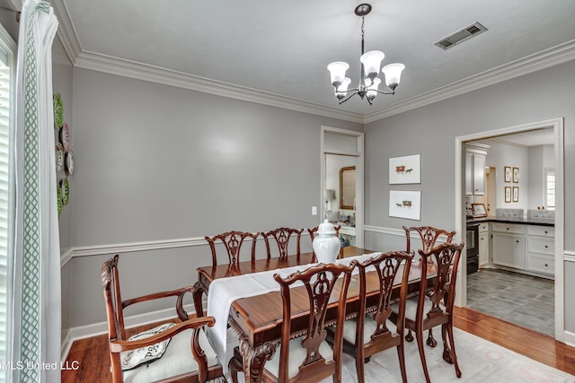 221 Boxwood Cir, Brandon, MS 39047 - dining space with a chandelier, light wood-type flooring, ornamental molding, and baseboards