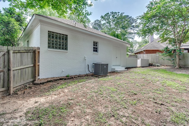 221 Boxwood Cir, Brandon, MS 39047 - rear view of property featuring brick siding, central AC unit, and a fenced backyard