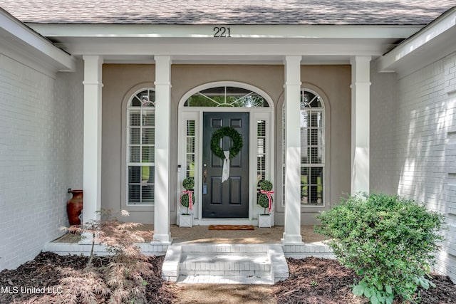 221 Boxwood Cir, Brandon, MS 39047 - entrance to property featuring roof with shingles, covered porch, and stucco siding