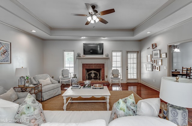 221 Boxwood Cir, Brandon, MS 39047 - living area featuring crown molding, wood finished floors, a raised ceiling, ceiling fan, and a fireplace