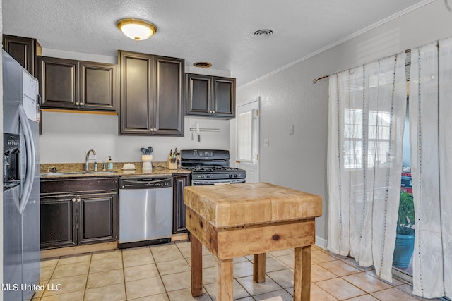 kitchen featuring a wealth of natural light, ornamental molding, sink, and stainless steel appliances