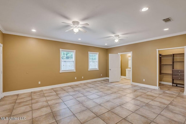 unfurnished bedroom featuring ceiling fan, a spacious closet, ornamental molding, and light tile patterned floors