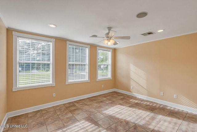 spare room featuring a wealth of natural light, ornamental molding, and ceiling fan