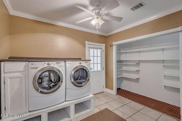 laundry area with washer and dryer, light tile patterned flooring, cabinets, and ornamental molding