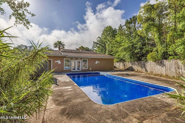 view of swimming pool with french doors