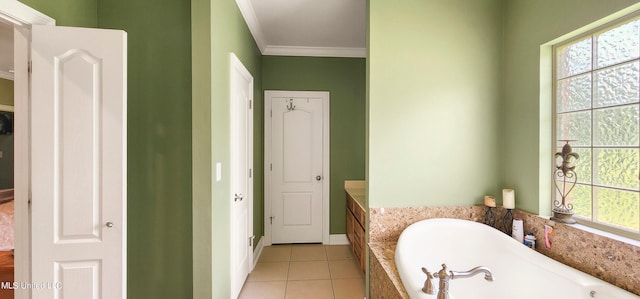 bathroom featuring tile patterned flooring, ornamental molding, and a tub to relax in