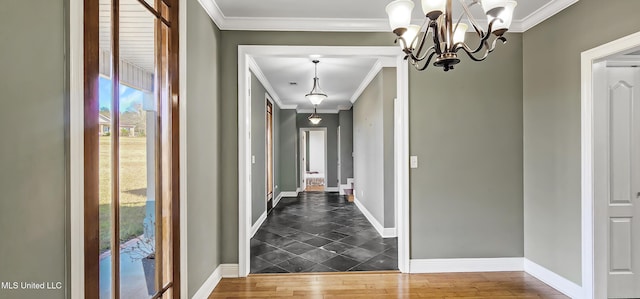 hall with crown molding, a chandelier, and dark hardwood / wood-style floors