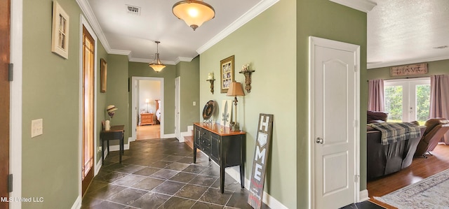 corridor with french doors, a textured ceiling, and ornamental molding