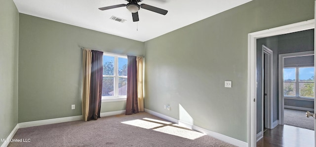 carpeted empty room featuring ceiling fan