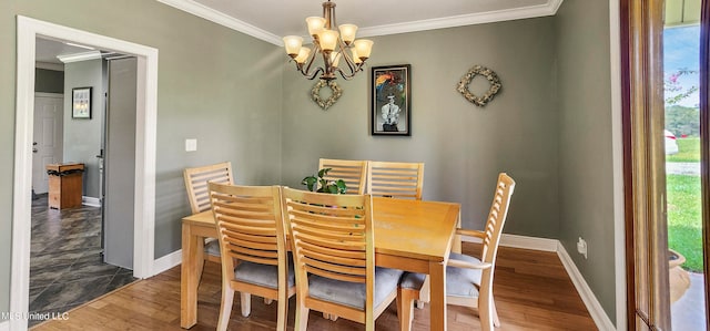 dining room with a chandelier, crown molding, a wealth of natural light, and dark wood-type flooring