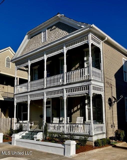 view of front of property with a balcony and covered porch