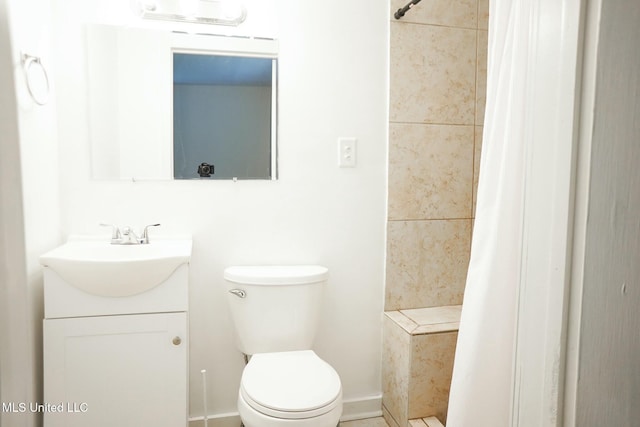 bathroom with walk in shower, vanity, and toilet